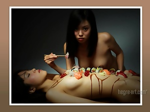 Asian girl eats sushi off her hot friend