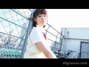 Cute Japanese schoolgirl in sleeveless cardigan