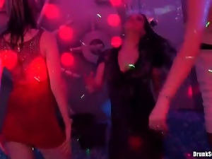 Ladies in tight dresses dance at the club