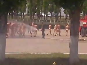 Nude soldiers get hosed down