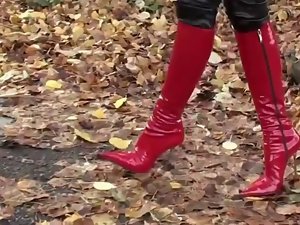 attractive lassie walking in leatherfetish panty, corset & red boots