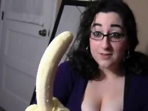 Big boob dark haired licking banana